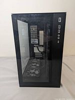 Front view showing tempered-glass panel and side-mounted I/O ports on Lian Li O11 Dynamic case