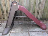 Side profile of slide showing steps, support arm, wide base