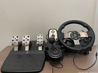 Full view of wheel, shifter and pedal set on table
