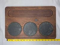 Front of board showing stone inlays, trough and magnet with tape for scale