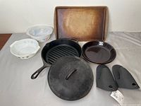 All items arranged: cast iron grill pan & lid, stoneware pan, pie plate, two casserole dishes, two oven mitts