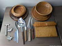 Group shot of all items showing bowls, bases, board, spreader, cheese tools, markers