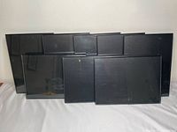 Front view of all eight black frames stacked