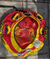 Top view of entire snow tube showing graphics, handles, and tote strap.