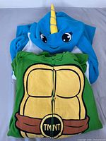 Stacked view showing TMNT shell front and narwhal hood