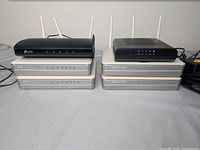 Stacked view of all routers and modems, front LED panels visible