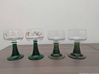 All four green-stemmed glasses front view