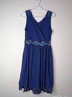 Full front view of blue sleeveless dress on hanger showing overall style and length