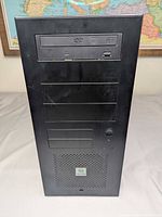 Front view showing drive bays, optical drive, mesh intake and controls