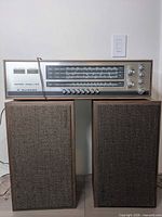 Receiver sitting on two matching speakers