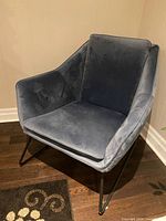 Full view of navy blue velvet armchair