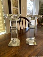 Front view of both crystal candlestick holders standing on table