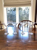 Four martini glasses lined on table