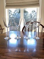 Front view of all four clear glass wine glasses on table