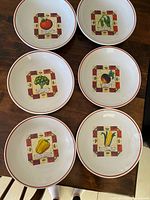 All six ceramic bowls showing assorted vegetable designs