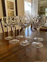 Six clear balloon wine glasses on table