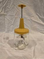 Full view of assembled manual food chopper standing upright