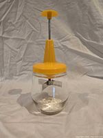 Full view of assembled yellow-top Androck food chopper