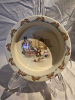 Front view of Bunnykins bowl showing interior scene and rim pattern