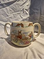 Front view showing Bunnykins scene and two handles