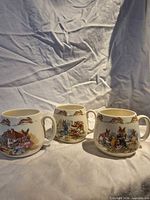 Front view of all three Bunnykins mugs side by side