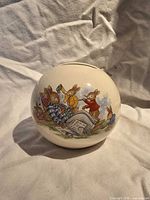 Front view of spherical Bunnykins ceramic money bank showing rabbit scene