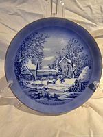 Front view of plate showing full winter scene and gold rim