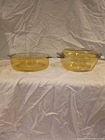 Both amber glass pieces side by side on white backdrop