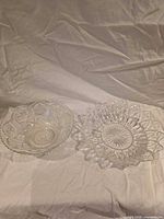 Both clear pressed glass star-shaped bowls side by side