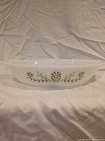 Side profile showing green floral pattern on white dish