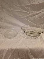 Both glass bowls side by side on cloth backdrop