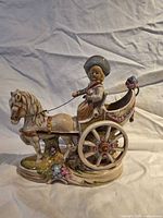 Full view of porcelain figurine showing horse, carriage and boy