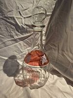 Full frontal view of decanter showing cranberry band and stopper