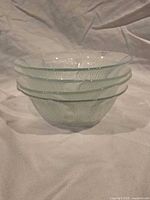 Stack of four clear textured glass bowls