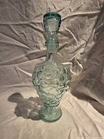 Full view of grape-form decanter with stopper inserted