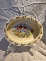 Full view of oval bowl showing rim and central Family Photo scene