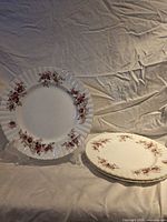 Front view of plate on stand showing full Lavender Rose pattern