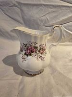 Front view of Royal Albert Lavender Rose creamer showing pattern and gold trim