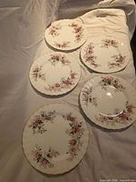 Five Royal Albert Lavender Rose dessert plates displayed