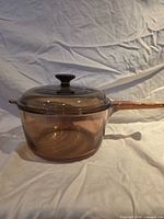 Side view of Corning Visions amber saucepan with lid