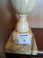 close view of alabaster base and marble square foot