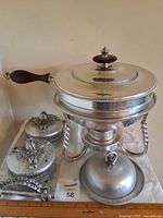 Overall view showing chafing dish, two lidded canisters on tray, butter dish