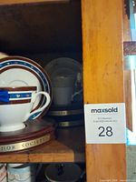 Cabinet shelf showing blue ribbon stripe cup on 2009 Honor Society base