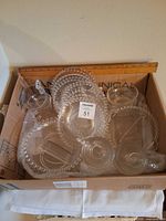 Box containing Candlewick glass plates, cups, and dishes