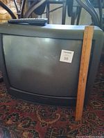 Front view of Daewoo CRT TV with ruler for size reference and remote on top