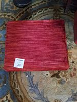 Top view of red upholstered footstool
