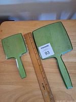 Front view of brush and mirror beside ruler showing sizes