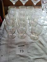 Group of twelve iridescent cordials arranged on table