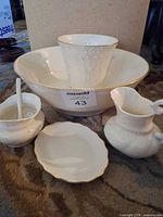 Group of ivory Lenox pieces: bowl, vase, creamer, condiment pot with ladle, plate