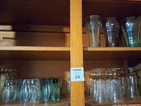 Shelf with fluted tall glasses and tumblers